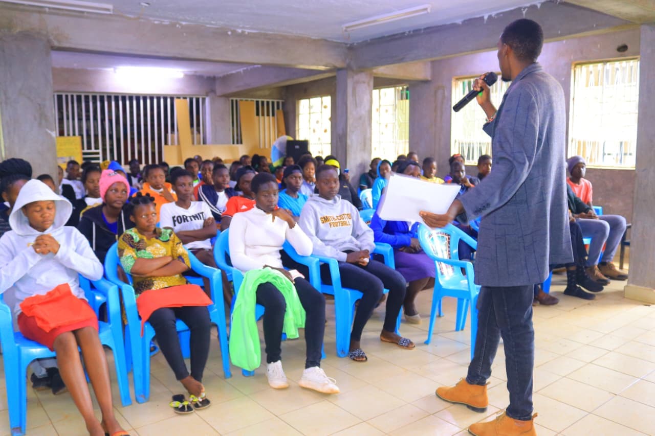 A facilitator speaking with students during a TALIRA educational mentorship session. — photograph 1