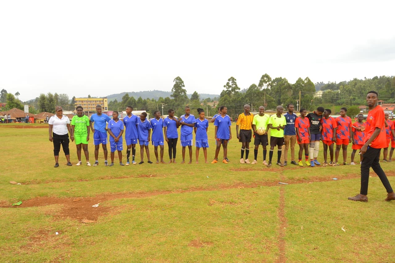 Football teams and organizers assembled on a community playing field. — photograph 1